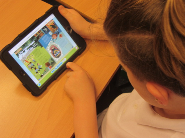 A child looking at a tablet screen